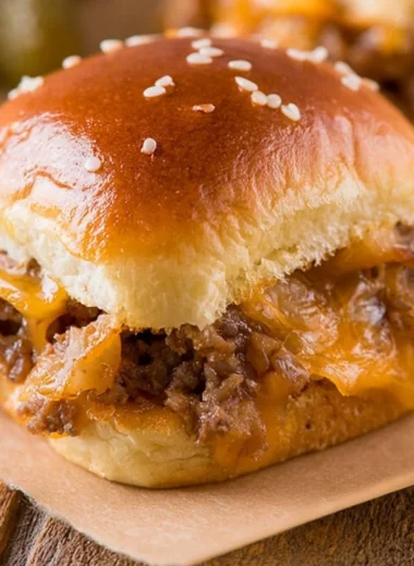 Delicious cozy cheeseburger sliders served on a wooden board.
