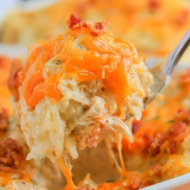 Deliciously creamy Crack Chicken Casserole topped with cheese and herbs