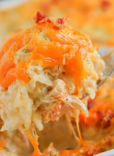 Deliciously creamy Crack Chicken Casserole topped with cheese and herbs