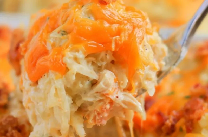 Deliciously creamy Crack Chicken Casserole topped with cheese and herbs