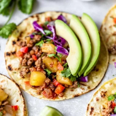 Cozy pineapple turkey tacos topped with fresh ingredients in a vibrant setting.