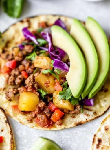 Cozy pineapple turkey tacos topped with fresh ingredients in a vibrant setting.