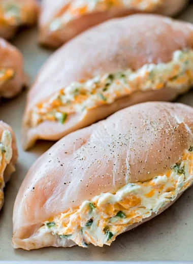 Creamy stuffed chicken breasts served with a side of vegetables