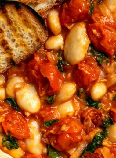 Creamy tomato basil butter beans dish served in a bowl with fresh herbs.