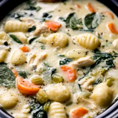 Crockpot Chicken Gnocchi Soup served in a bowl with fresh herbs