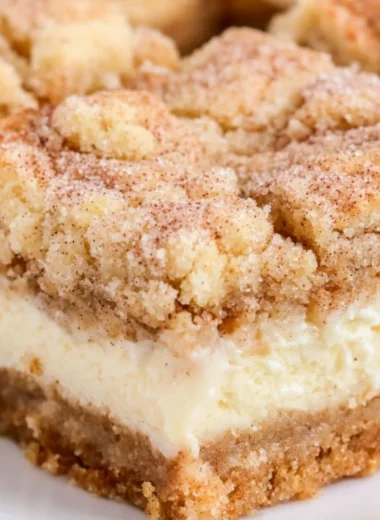 Delicious snickerdoodle cheesecake bars served on a plate