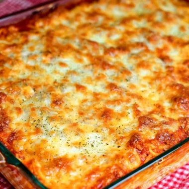 Delicious Ultimate Baked Spaghetti served in a bowl with melted cheese.