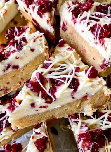 Homemade Starbucks copycat Cranberry Bliss Bars with cream cheese frosting and cranberries.